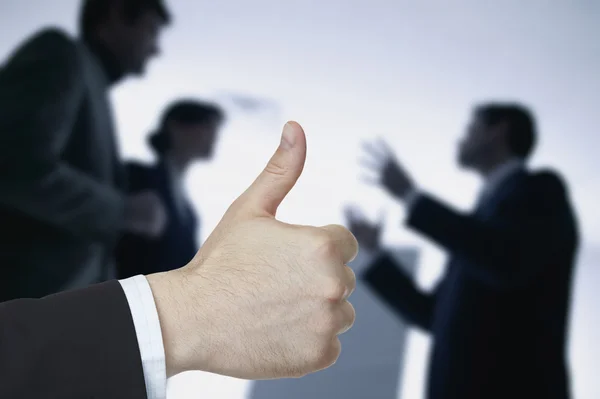 Business hand with thumb up on background business people Stock Picture
