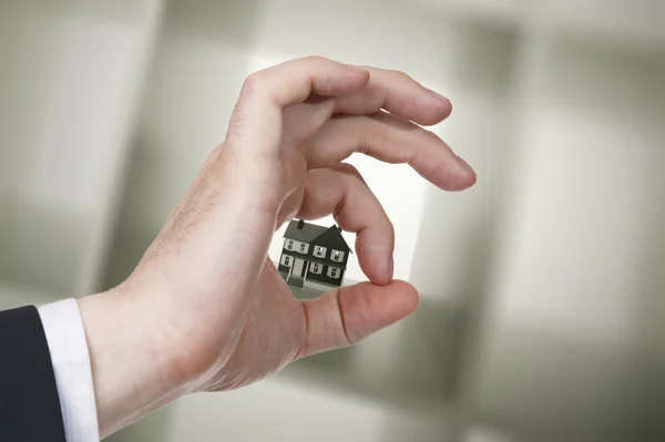 Business hand göra ok på bakgrunden hus — Stockfoto