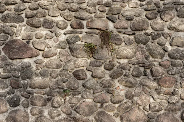 Ender bulunan büyük taşlı taş duvar. Eski bir Kale Duvarı. Arka plan olarak taş dokular. Ortaçağ Şatosu.