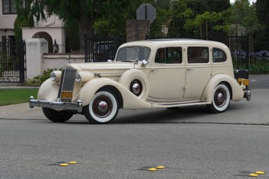 San Marino, California, USA - June 13, 2016: image of a prestine circa 1935 Packard Twelve classic car shown leaving from Lacy Park. clipart