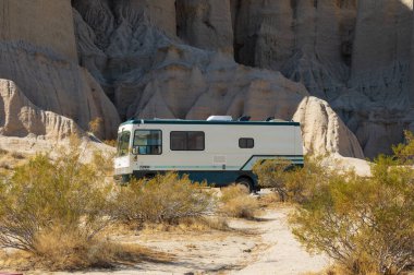 Red Rock Canyon State Park, California, USA - February 6, 2021: image of a Trek Pathmaker RV shown against an eroded mountain side.