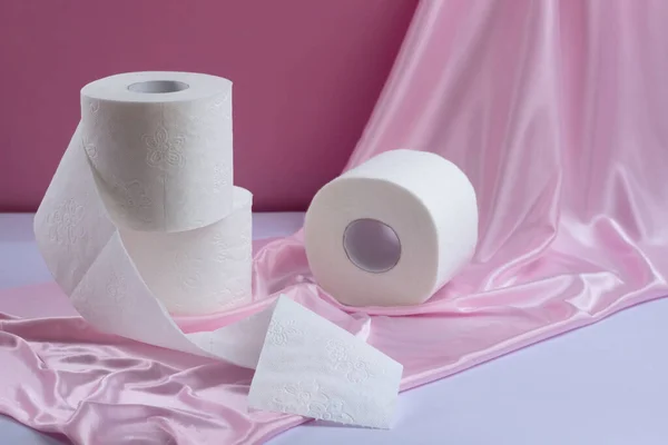 Hree Rolls White Perforated Toilet Paper One Unwound Pink Silk — Stock Photo, Image