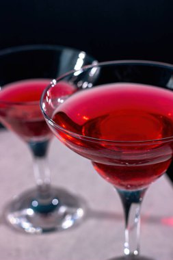 Red cocktail in a margarita glass on a dark background
