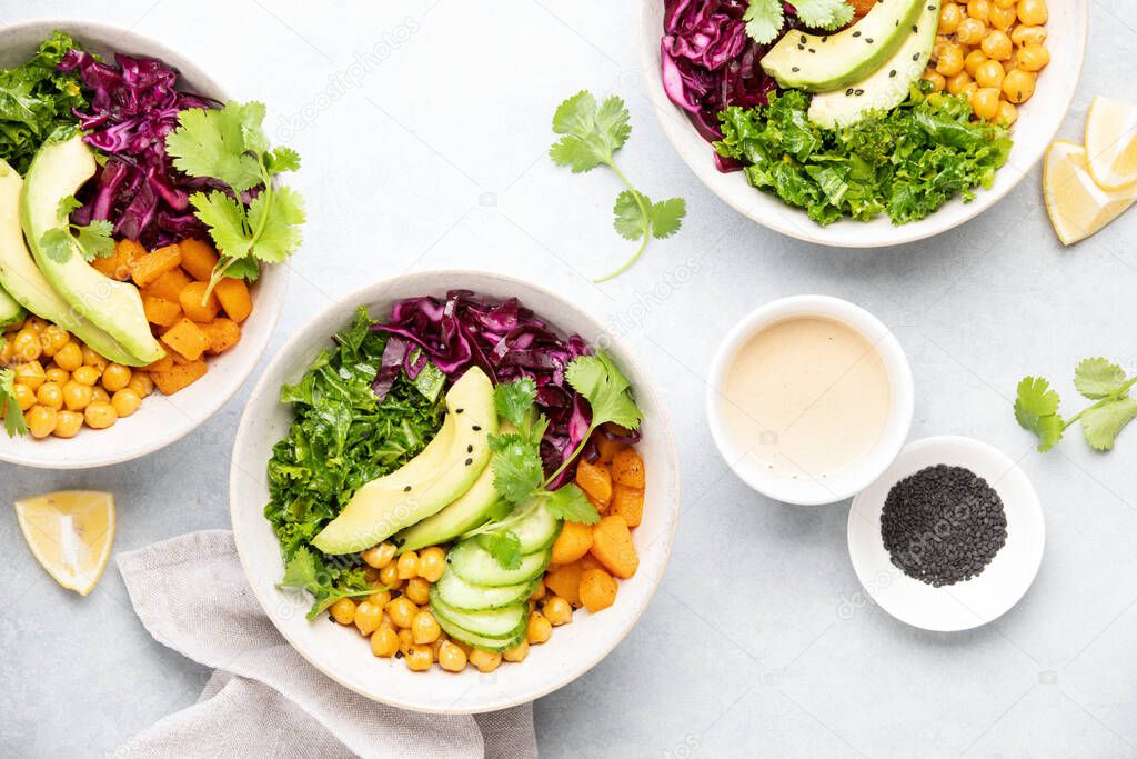 Vegan Buddha bowl with roasted chickpeas and tahini sauce, top down view