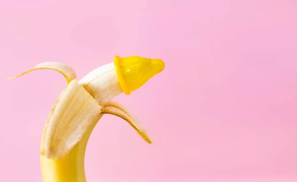 Gelbes Kondom Auf Einer Banane Auf Rosa Hintergrund Das Konzept — Stockfoto