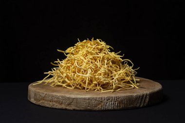 Egg noodles on a black background. Homemade traditional noodles on a wooden board. pasta