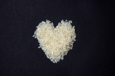 Pirinç kalp şeklinde serilmişti. Yemek yapmayı seviyorum. Siyah arkaplanda pirinç