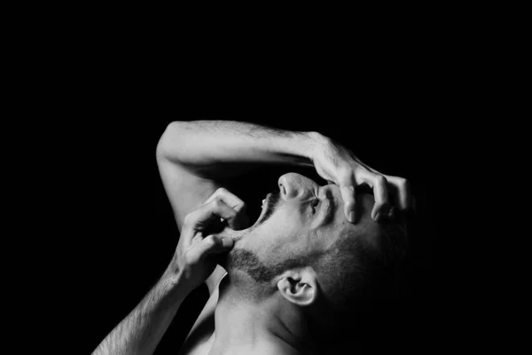 Man Screams Madness Clutching His Face His Hands Black Background — Stock Photo, Image