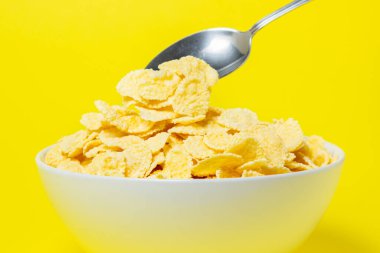 Sarı arka planda mısır gevreği. Faydalı ve lezzetli bir kahvaltı. Diyet yemek.