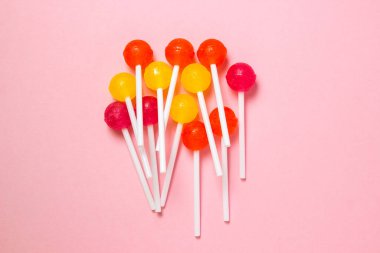 Lollipops on a pink background. Various fruit candies. sweet treat