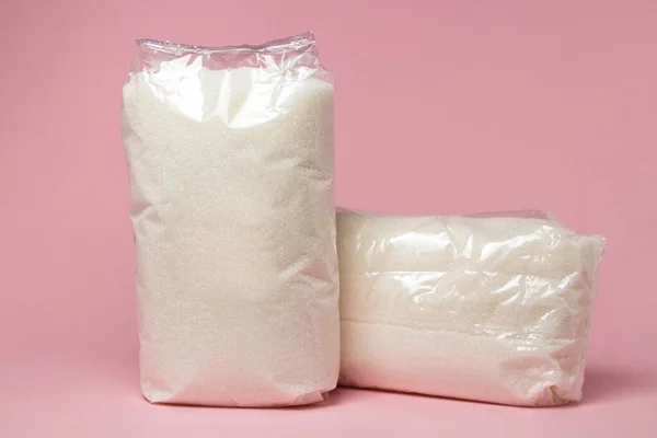 Pembe Arka Planda Şeffaf Bir Pakette Şeker Paketlenmiş Şeker Gerekli — Stok fotoğraf