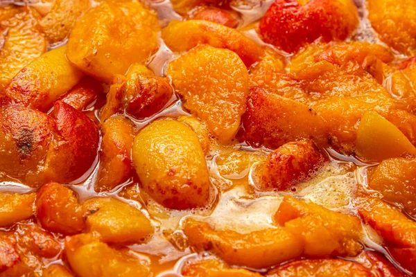 Kayısı reçeli hazırlığı. Şerbetli kayısı parçacıkları. Tatlı meyve tatlısı