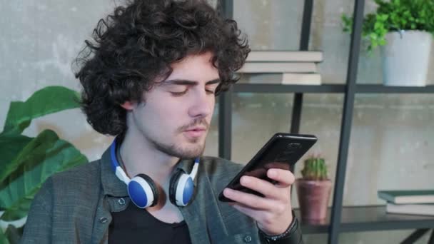Mladý Běloch Sedí Stolem Domácí Kanceláři Mluví Reproduktoru Smartphonu Millennial — Stock video