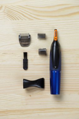 trimmer for nose, ears, eyebrows. Set for eyebrows, nose and ears. Personal care. Flat lay on a wooden background.