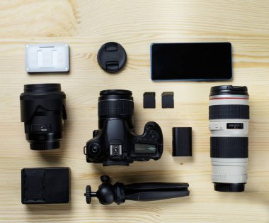 Flat lay composition with equipment for professional photographer on the table.