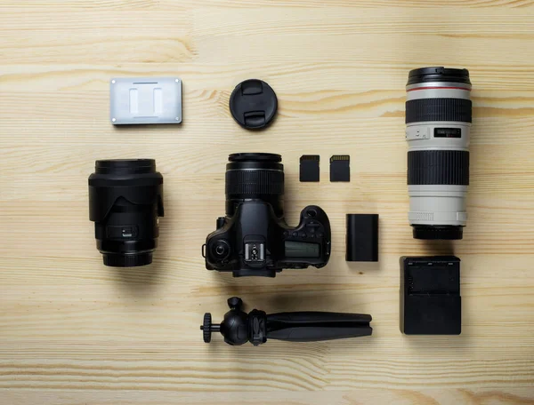Flat lay composition with equipment for professional photographer on the table.