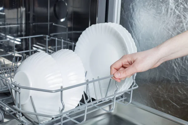 Girl Takes Out Clean Plate Dishwasher — Stock fotografie