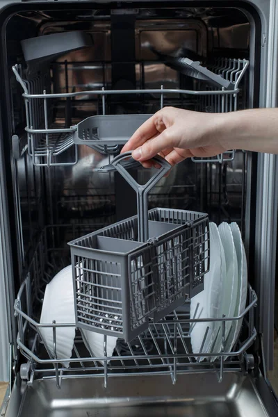 Open Dishwasher Girl Holds Basket Forks Spoons Built Dishwasher — Stock Fotó