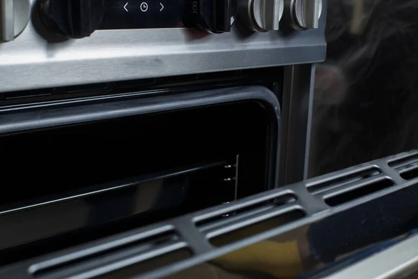 stock image a woman in red rubber gloves cleans a gas stove. cleaning in the kitchen.