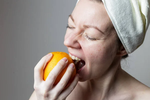 Young Woman Bath Towel Woman Eats Orange — стоковое фото