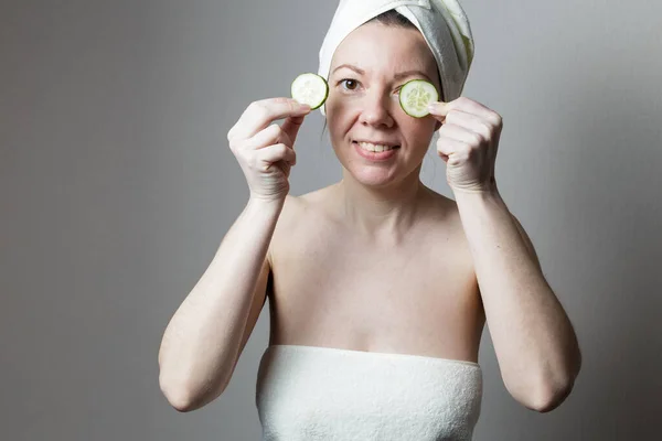 Young Woman Bath Towel Woman Holds Cucumbers Her Eyes — Stok Foto