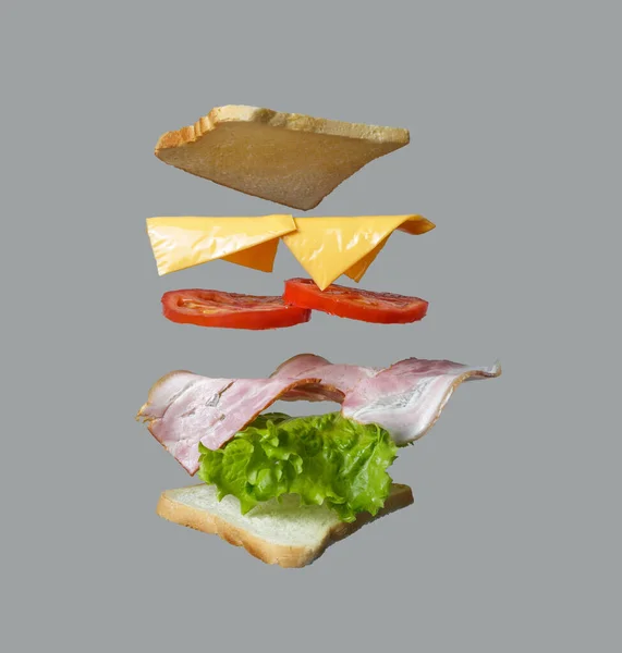 Flying Sandwich Bread Ham Tomato Onion Salad Isolated Gray — Fotografia de Stock