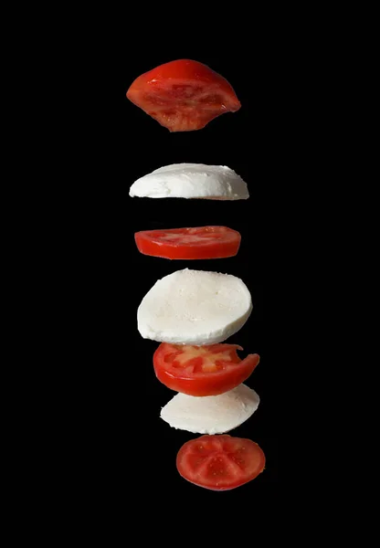 Flying Tomato Mozzarella Isolated Black Background Frozen Motion Copy Space — Stockfoto