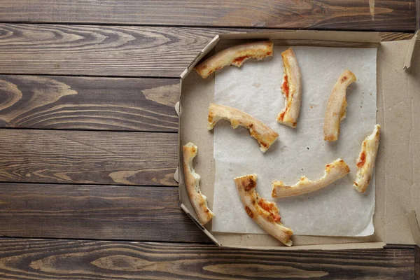 empty pizza box on wooden. Leftover pizza in a box.