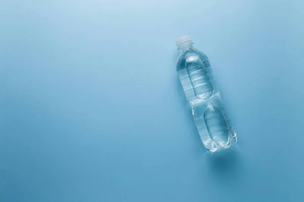 the concept of clean water. water bottle on blue background