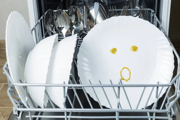 well-washed dishes in the dishwasher. a surprised emotion is depicted on a plate