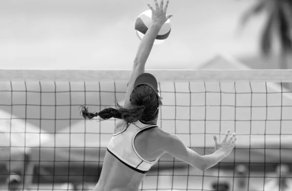 A Beach Volleyball Player Is Rising Up To Spike The Ball In Black And White Banner Image Format