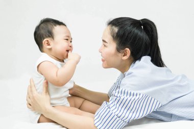 Selective focus beautiful mom hugs her baby after crying with love and caring, Mother showing love to toddler with smiling.