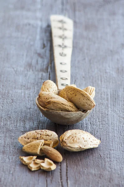 Almonds on wooden table — Stock Photo, Image