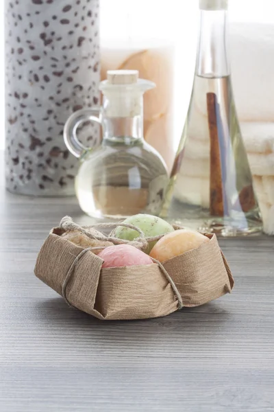 Soap balls with coffee candle and cinnamon massage oil — Stock Photo, Image