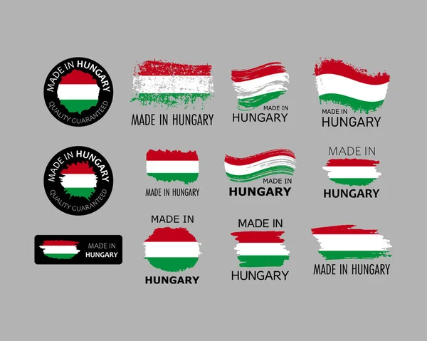 Çıkartma takımı. Macaristan malı. Macar bayrağı şeklinde fırça darbeleri. Fabrika, üretim ve üretim ülkesi konsepti. Etiket ve ambalaj için tasarım ögesi. Vektör renkli illüstrasyon.