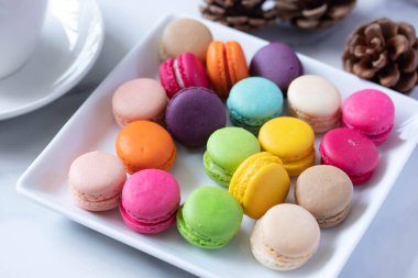 Beyaz tabakta renkli makaronlar.