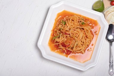 Beyaz tabakta Tayland papaya salatası. Beyaz arka planda popüler yemekler.