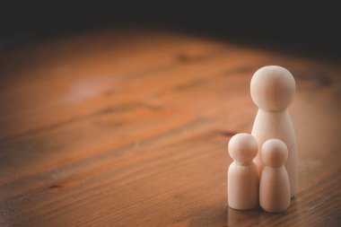 Mother and son figure wooden figure. Small family concept. Copy space.