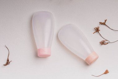 Plastic cosmetic bottle on light background.Face and body skin care with marine minerals.
