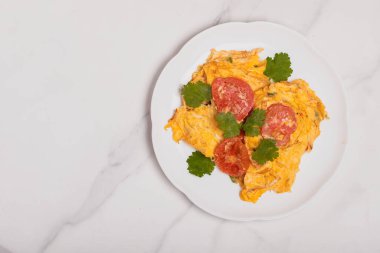 Oil-free tomato omelette in a white plate. Healthy food ideas for weight loss.