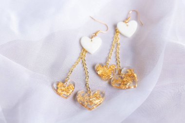 Heart-shaped earrings made of resin, handmade jewelry.