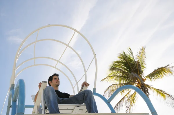 Boy sitting in beach chair — Stock Photo, Image