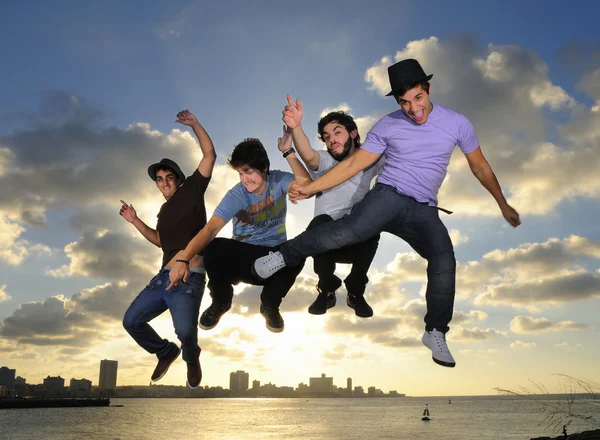 Young male team jumping outdoors — Stock Photo, Image