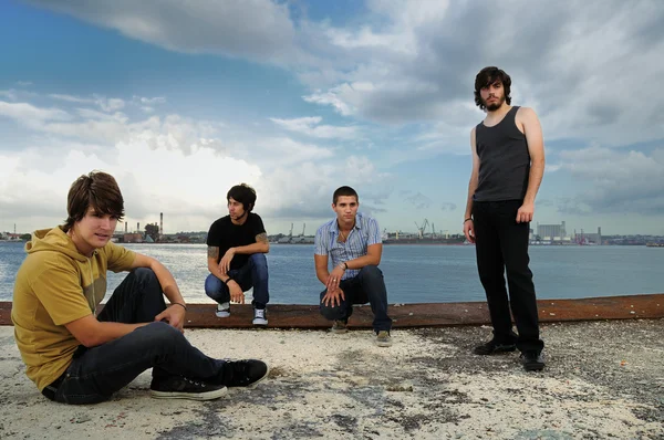 Casual trendy team sitting at the port — Stock Photo, Image