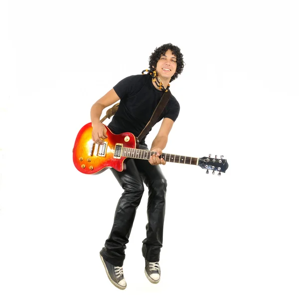 Young guy jumping with electric guitar — Stock Photo, Image