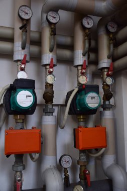 Çeşitli gaz kazanı basınç göstergeleri ve içinden demir borular çıkıyor ve basınç anahtarları var.