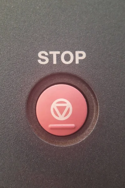 Close-up STOP button in red with an inscription above it and a special symbol applied to it. — Stock Photo, Image