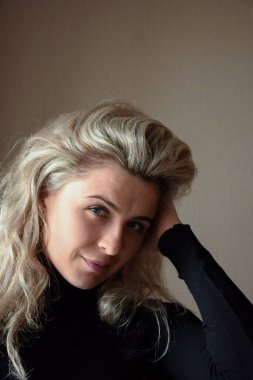 Young attractive blonde woman white race looking at camera and smiling