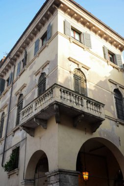Stone decorative corner balcony of an ancient building with several floors in the old town