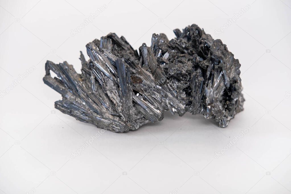 Mineral crystals of natural antimonite. Isolated on a white background